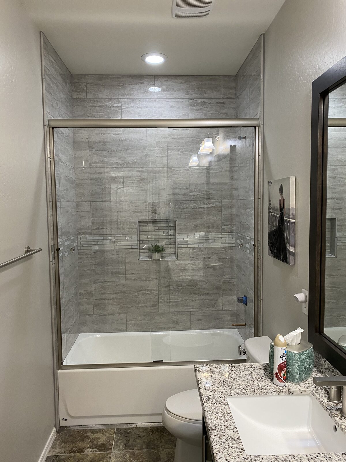 Framed bypass sliding shower doors over a tub with brushed nickel finish