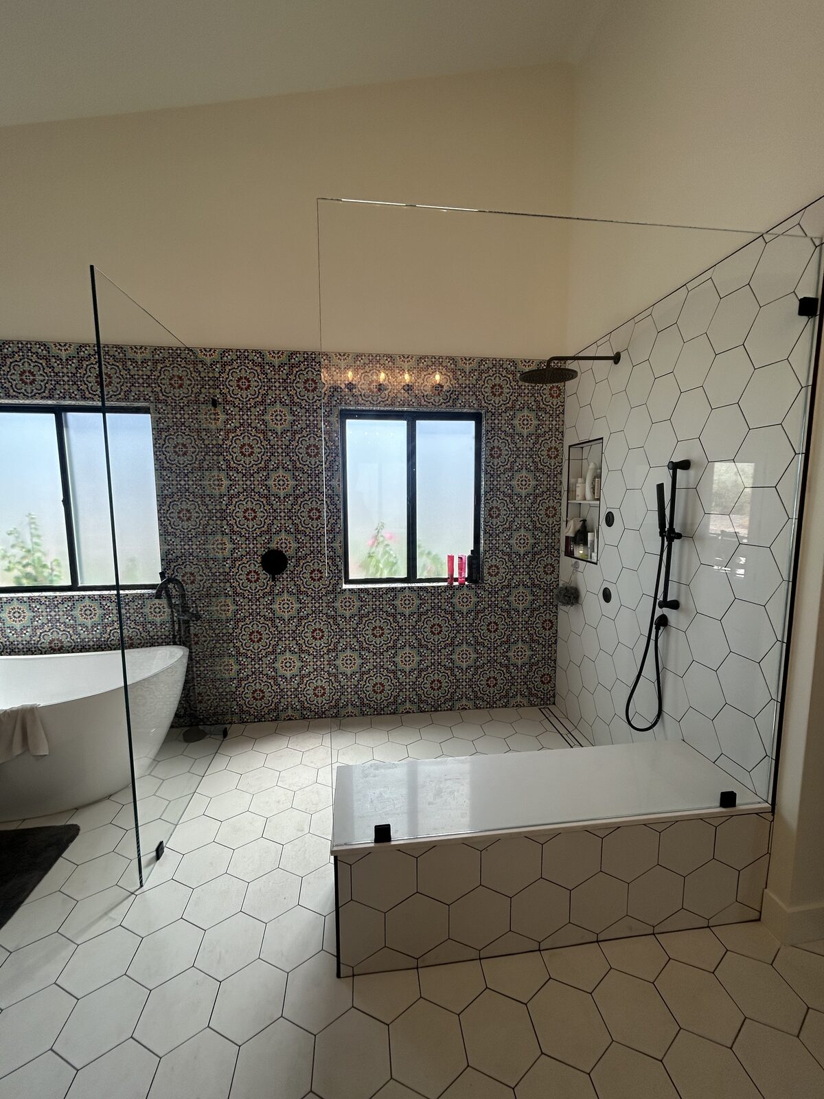 Hexagon tile bathroom with soaking tub and fixed glass shower panel